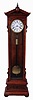 Lenzkirch, Germany, standing regulator, model 478, walnut and matched walnut veneer case of architectural form, ornamented with applied moldings, turned elements, and carving, and with a drawer in the base, and resting on turned feet, Roman numeral white enamel dial with brass bezel, blued steel Breguet style hands, and with center seconds hand, brass 8 day timepiece movement with deadbeat escapement and Vulliamy pallets, brass clad weight, ebonized pendulum rod with brass ball, serial #309868, c1875