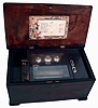 Swiss music box, 8 tune cylinder player with three bells, one butterfly, two plain strikers, inlaid grain-painted case, printed paper lithograph from Lausanne inside lid, c1900