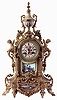 Samuel, Marti, France, for J.E. Caldwell & Co., Philadelphia & Paris, mantel clock, cast brass case with architectural and naturalistic ornament, the front set with a painted porcelain panel depicting a young couple in a landscape, the top with porcelain urn decorated with a portrait of a young woman, Roman numeral porcelain dial with gilding, and putto with basket of flowers, 8 days, time and strike pendule a Paris movement, c1900