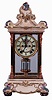 Ansonia Clock Co., New York, NY, "Crystal Regulator No. 5" in a gilt and brass case with a Royal Bonn top and base and a spring driven, 8 days, time and hour/half-hour strike movement with a visible escapement, c1906.