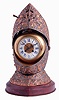 France, for Mitchell, Vance and Co., New York, a spectacular table clock in the form of a knights helmet, constructed of sheet copper, the chased ground finished in patinated silver, and festooned with repousse ornament, the decoration consisting of trailing vines and leaves, satyr masks, dragons, armorial trophies, and each side with a scene probably depicting Richard II meeting with the rebels during the Peasants Revolt of 1381, the various forms further enhanced by the application of gold, the visor opening to reveal a clock, with Roman numeral cartouches on a pale yellow enamel ground, blued steel hands, the hour in the form of a battle axe, and 8 days, time and strike movement with lever platform, striking on a coiled gong, all resting on a conforming, brass trimmed griotte marble base, c1890