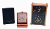 Clocks- 2 (Two): Both LeCoultre, the first a ref. 2173 musical alarm clock, gilt case with lucite dial, and gilt luminous stick hands, the other a folding travel alarm clock, lacquered brass folding case with Arabic numeral and arrow marker metal dial and luminous baton hands, with its original box and instructions, both mid 20th century
