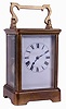 France, carriage clock with travel case, gilt brass Corniche variant case with beveled glasses, Roman numeral white enamel dial, blued steel hands, 8 days, time and strike movement with lever platform, leather covered wooden case with sliding panel and key, c1900