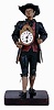 Germany, Black Forest "Uhrentrager" or clock peddler, the figure of polychrome painted sheet iron and in traditional dress, carrying a shield clock at his right, the clock with 30 hour pendulum timepiece, the back plate stamped "Schmutzer", Roman numeral white enamel dial and steel hands, also with another clock slung over his back with sliding front revealing a compartment for storing the key, his left hand clutching three pendulums, all mounted to wooden base, mid 19th century