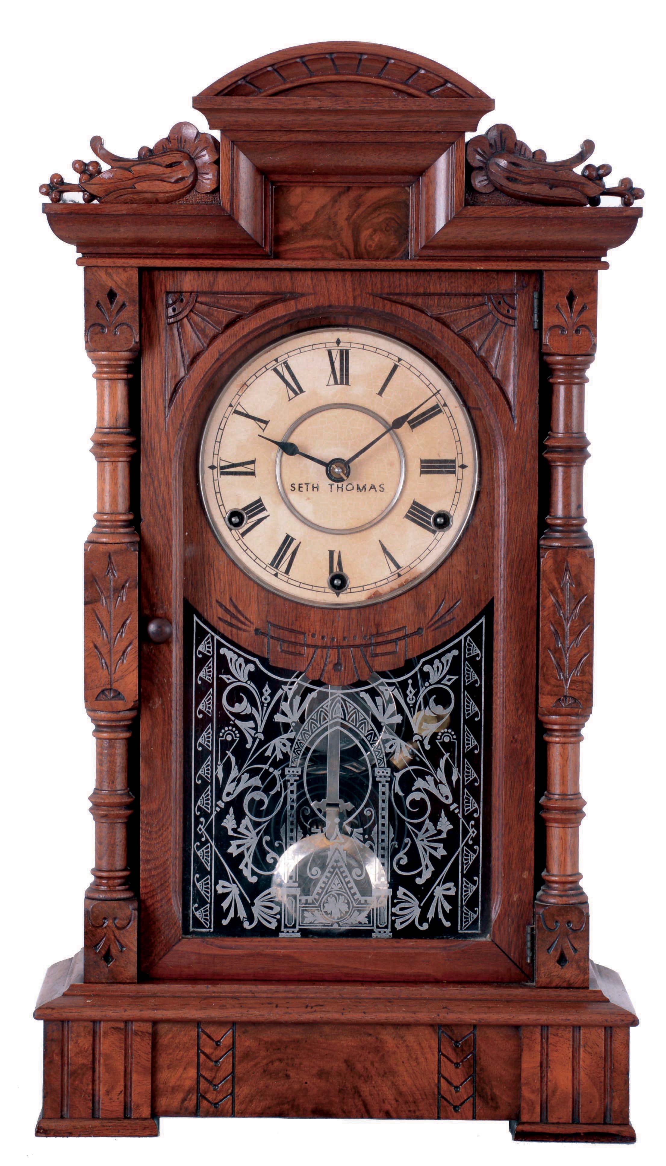 Seth Thomas Clock Co., Thomaston, Conn., "Hecla" mantel clock in a walnut case with a three train, 8 days, spring, time and strike movement, striking the quarter hours on 2 cup bells and the hours on a cathedral bell, c1885. — Antique Clocks Price Guide