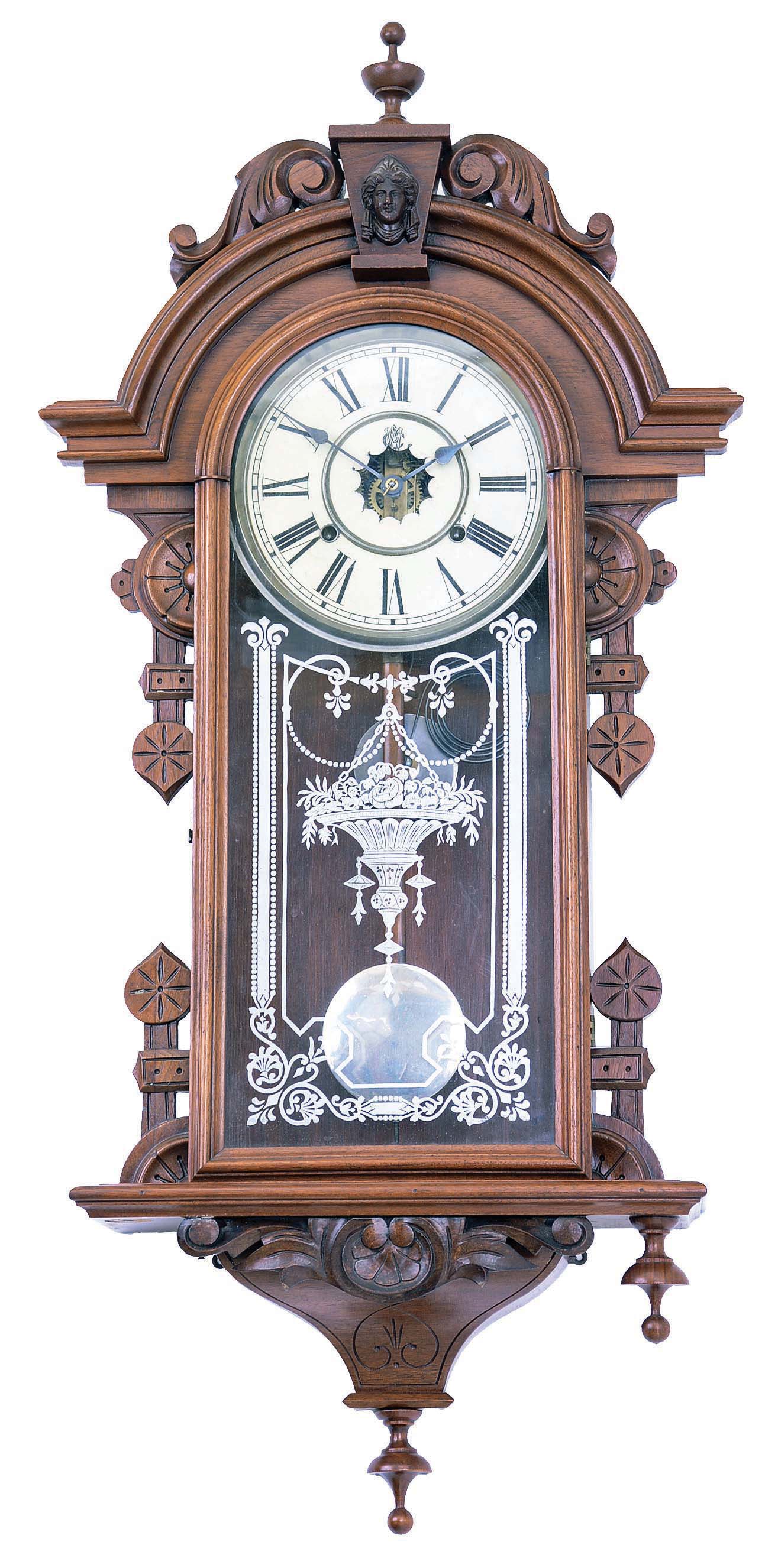 William L. Gilbert Clock Co., Winsted, Conn., "Columbia" wall clock with an 8 day spring driven brass time and strike movement in a walnut case. — Antique Clocks Price Guide