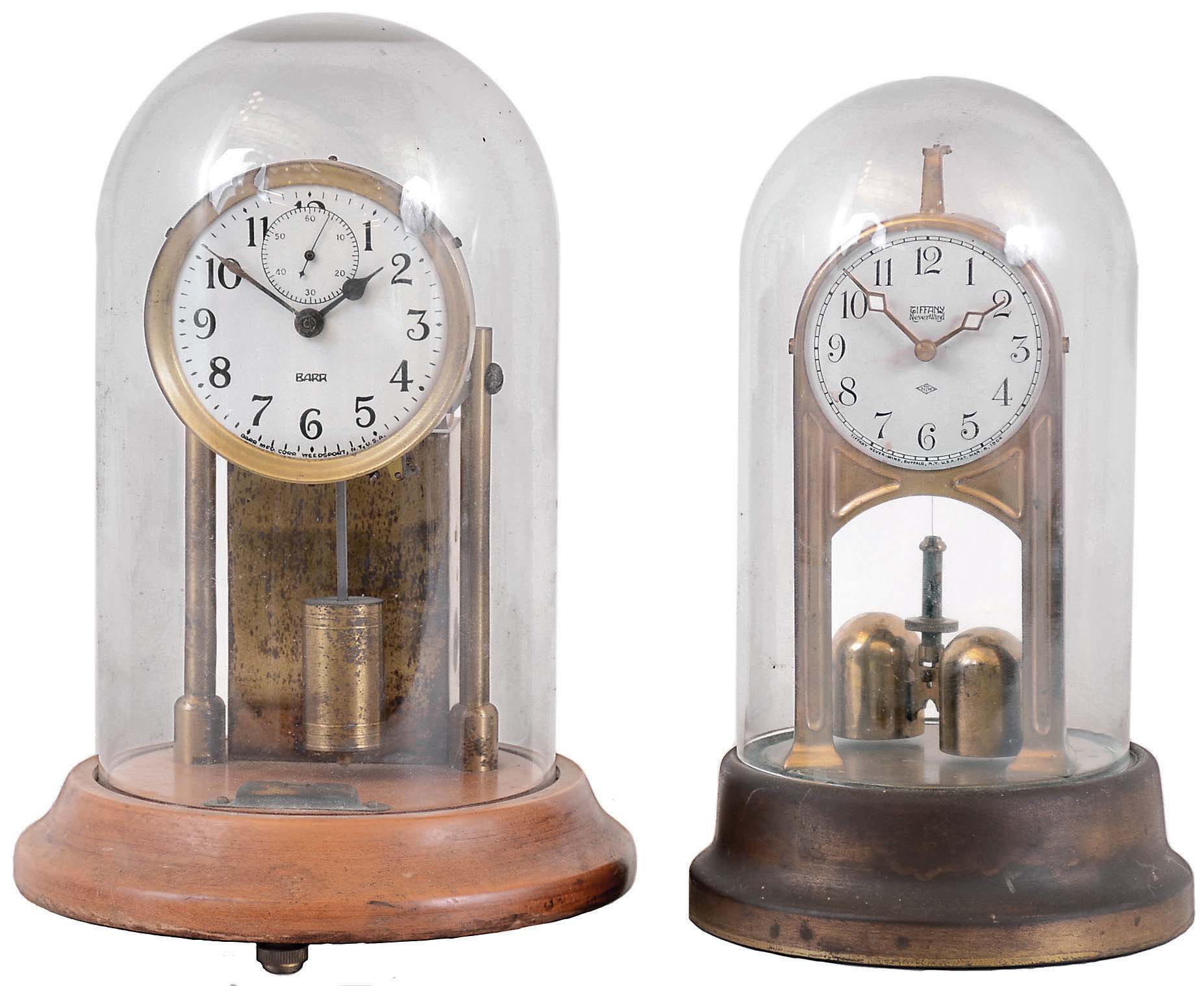Clocks- 2 (Two) battery powered electromechanical under glass domes: Barr Mfg. Co., on wood base, c1930; Tiffany Never-Wind with torsion pendulum, c1904 — Antique Clocks Price Guide