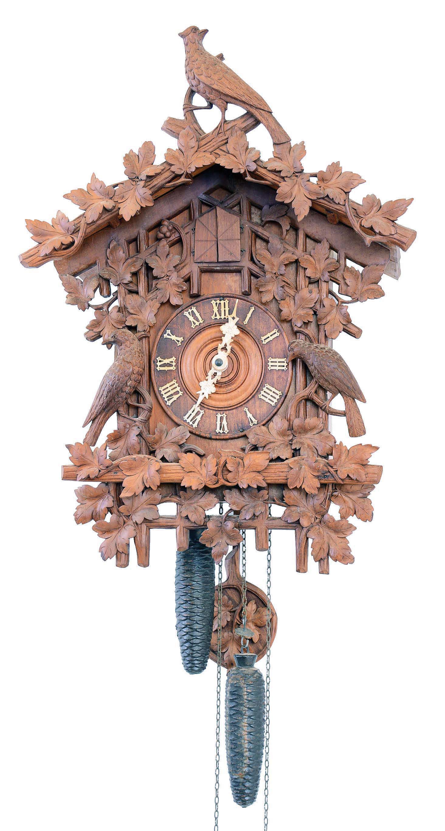 Cuckoo Clock, German Black Forest, large carved walnut 30 hour with oversize cuckoo, case "305" very similar to example shown in Appendix A, Beha catalogue, of Justin Miller book, No. 608. Three bellows provide cuckoo song counting on the hours, quail song on the half hours. c1880 — Antique Clocks Price Guide