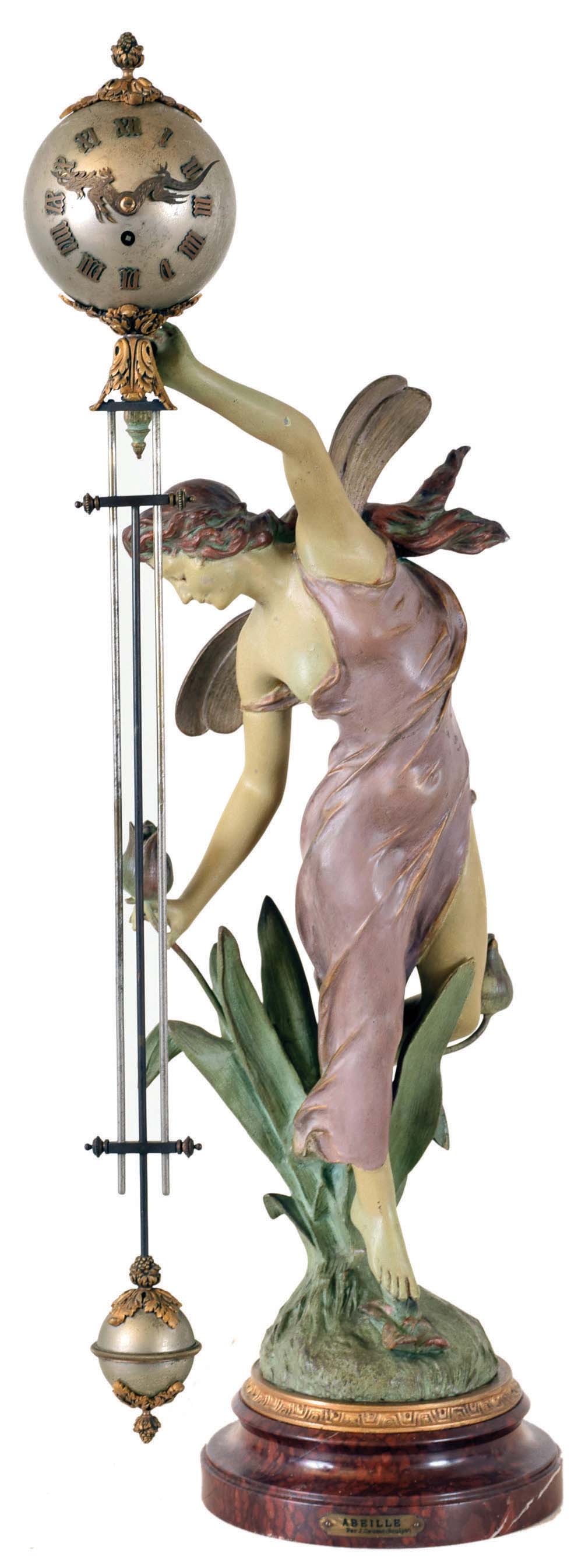 French swinger mystery clock, polychrome "Abeille", after sculptor J. Causse, with female fairy figure parading through tulips, supporting the extra long 28.5" clock and compound pendulum arm, spherical case with foliate and pineapple applique and dragon hands, applied Roman numerals containing the 8 days, time only movement, gridiron style assembly with ornamented foliate fall at bottom, all mounted on red marble base with J. Causse plaque — Antique Clocks Price Guide