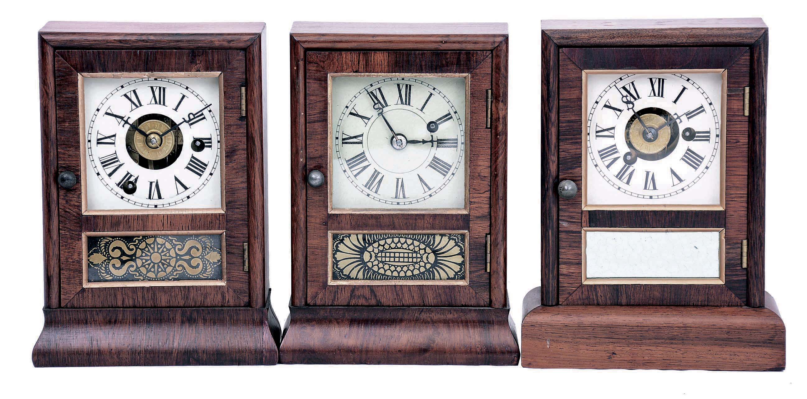 Clocks- 3 (Three): (1) Seth Thomas Clock Co., Plymouth Hollow, Conn., "Cottage" clock with a 30 hours spring driven brass timepiece movement in a rosewood veneered case; c1865. (2) Seth Thomas Clock Co., Thomaston, Conn., "Cottage" clock with a 30 hour spring driven brass time and alarm movement in a rosewood veneered case; c.1875. (3) Seth Thomas Clock Co., Plymouth Hollow, Conn., "Cottage" mantel clock with a 30 hours spring driven time and alarm movement in a rosewood veneered case. c1865. — Antique Clocks Price Guide