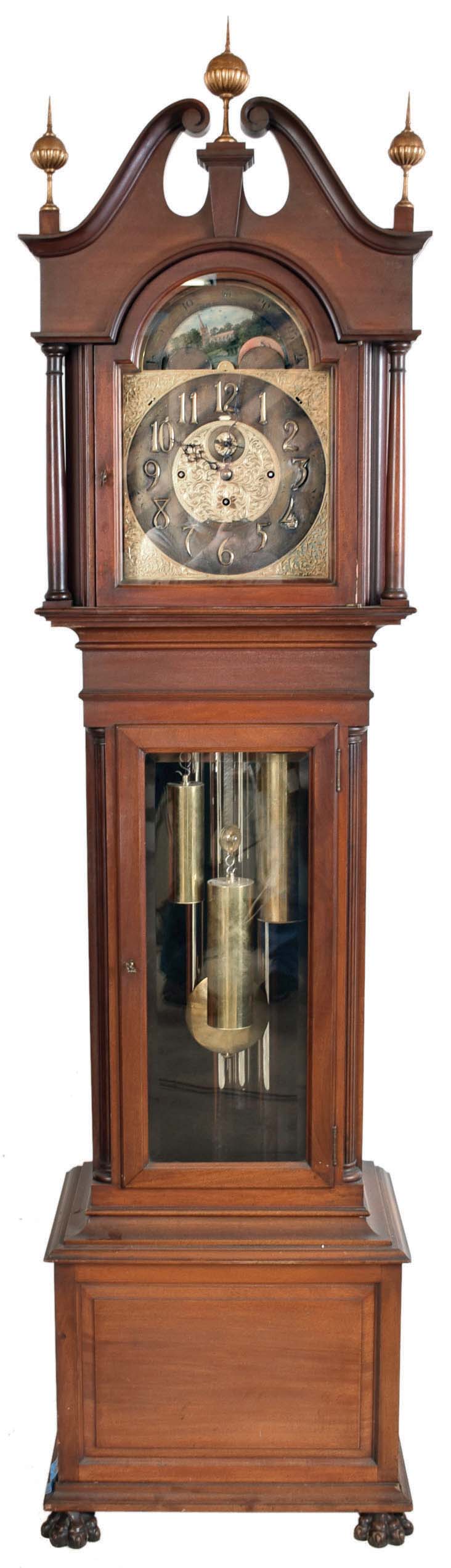 John J. Elliott, London, England for Schreve, Crump &amp; Low Co., Boston, Mass., tall clock, 8 day, time, strike and Westminster chime on 5 signed Harrington tubes, three train brass weight driven movement in a mahogany case with full columns flanking broken arch hood with gilded wooden ball and spire finials, beveled glass in trunk door and front paw feet. The brass dial has pierced brass corner spandrels and dial center, silvered chapter ring with applied brass numerals, hour strike / silent and Westminster / silent selectors and moon phase dial — Antique Clocks Price Guide