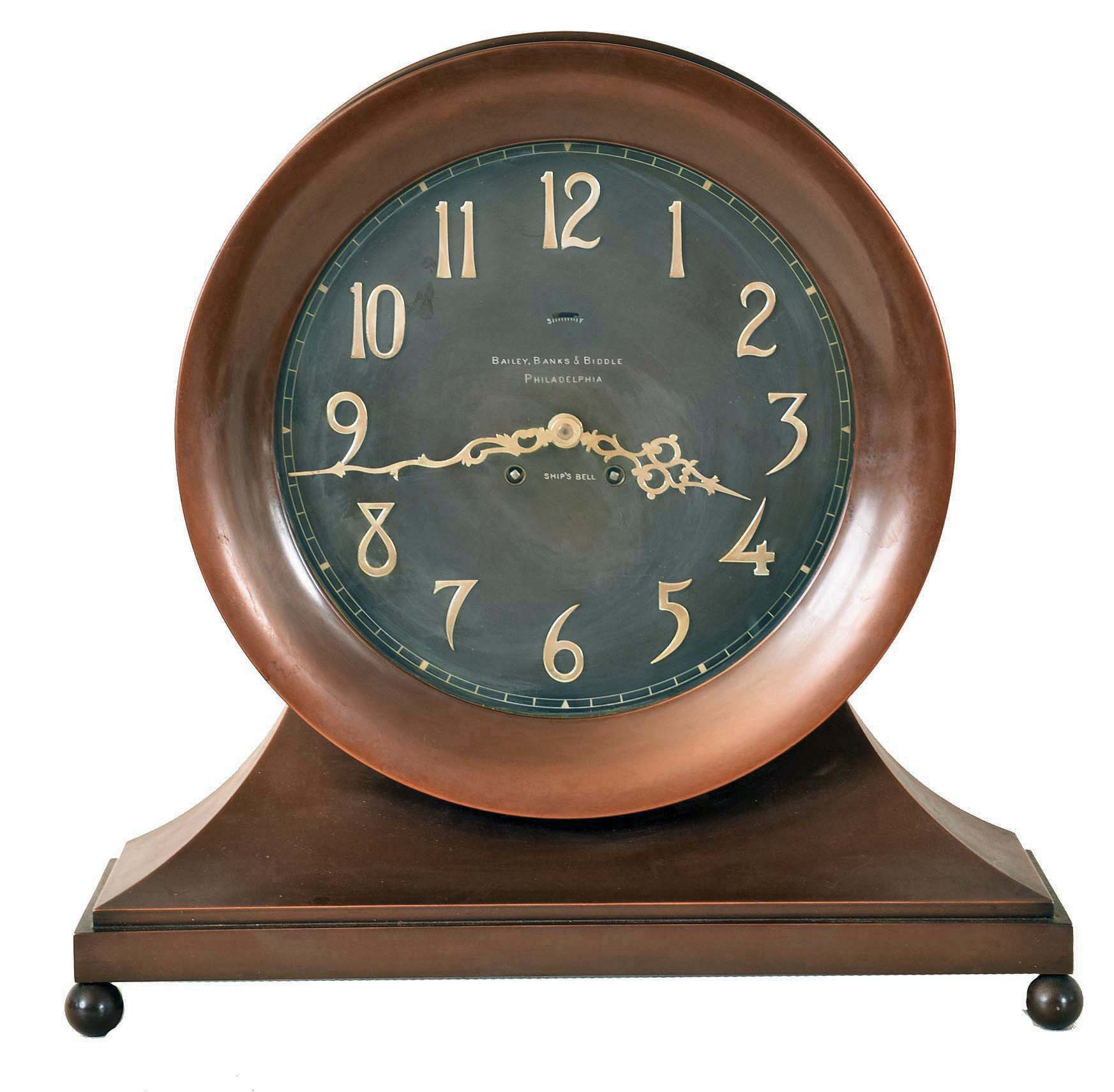 Chelsea Clock Co., Boston, Mass., "Copper Bronze Constitution Ship's Bell Clock" for Bailey, Banks &amp; Biddle, Philadelphia, 8 days, time and ship's bell strike, spring driven movement in a bronze finished brass case on ball feet with large 10" dial with applied silvered numerals and finely wrought hands, serial #34533 — Antique Clocks Price Guide