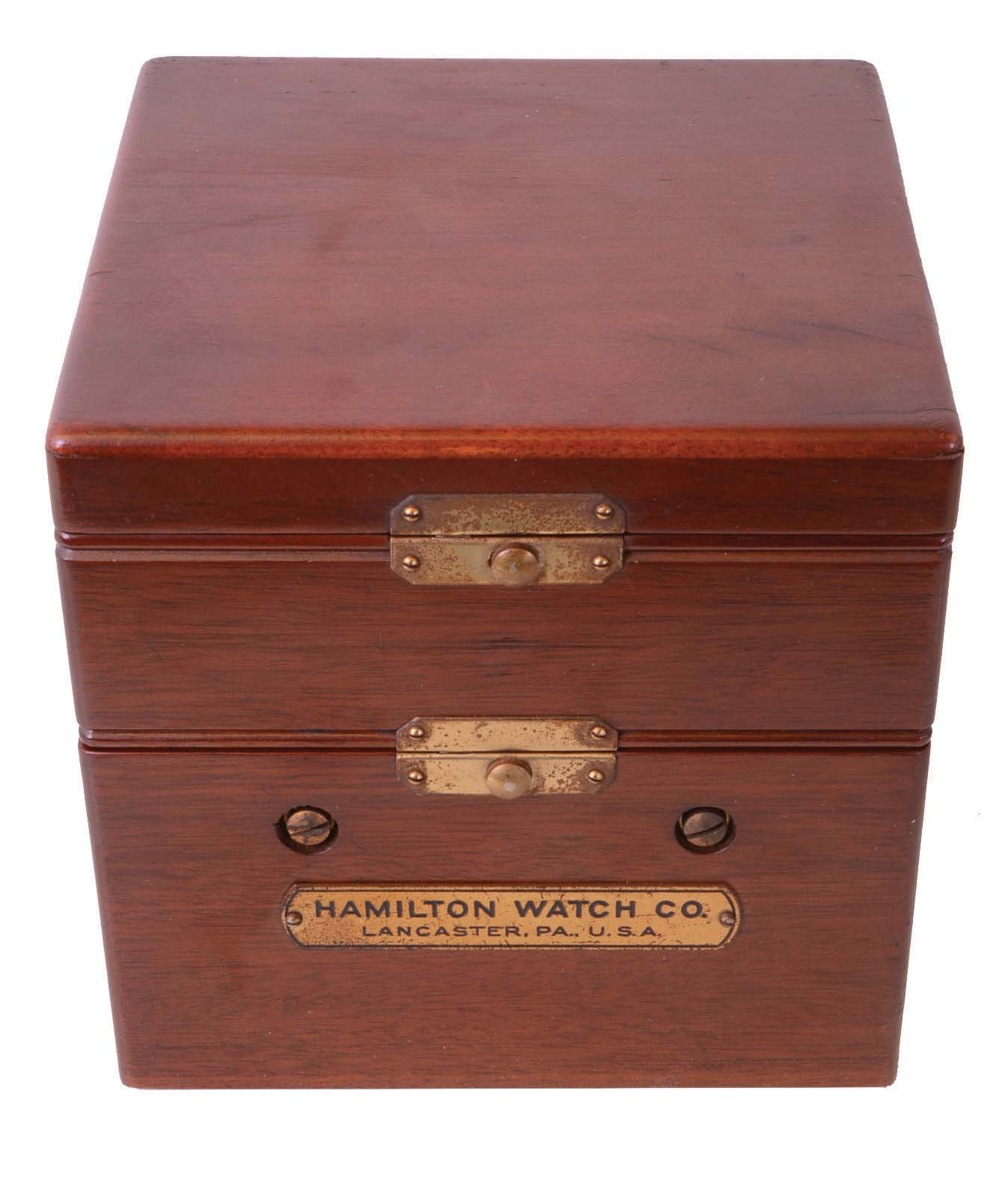 Hamilton Watch Co., Lancaster, Penn., model 22 chronometer watch with wind indicator, 35 size, 21 jewels, stem wind, pin set, adjusted to 6 positions and temperature, straight line damascened nickel plate movement, with lever escapement and micrometric regulator, Arabic numeral silvered metal dial, black steel spade and poker hands, the timepiece contained in a gimbaled bowl, and mounted in a mahogany box, serial #2F24760, c1940 — Antique Clocks Price Guide