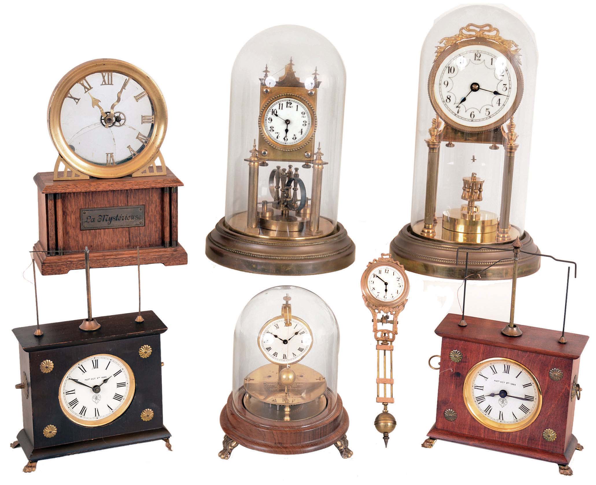 Clocks- 7 (Seven) German: three are Horolovar reproductions, two anniversary 400-day with disk pendulums, "La Mysterieuse" by Hamburg American, and Junghans swinging arm (no figural stand): 20th century — Antique Clocks Price Guide