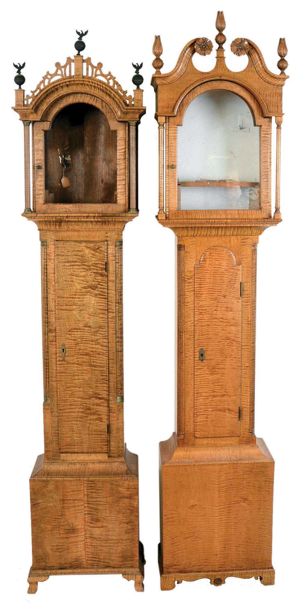 Tall Clock Cases Only- 2 (Two) professionally bench made in tiger maple: (1) broken arch top, flame finials, tombstone door on cutout bracket feet; (2) Roxbury style case with fluted corner columns having brass capitals and bases on ogee bracket feet — Antique Clocks Price Guide