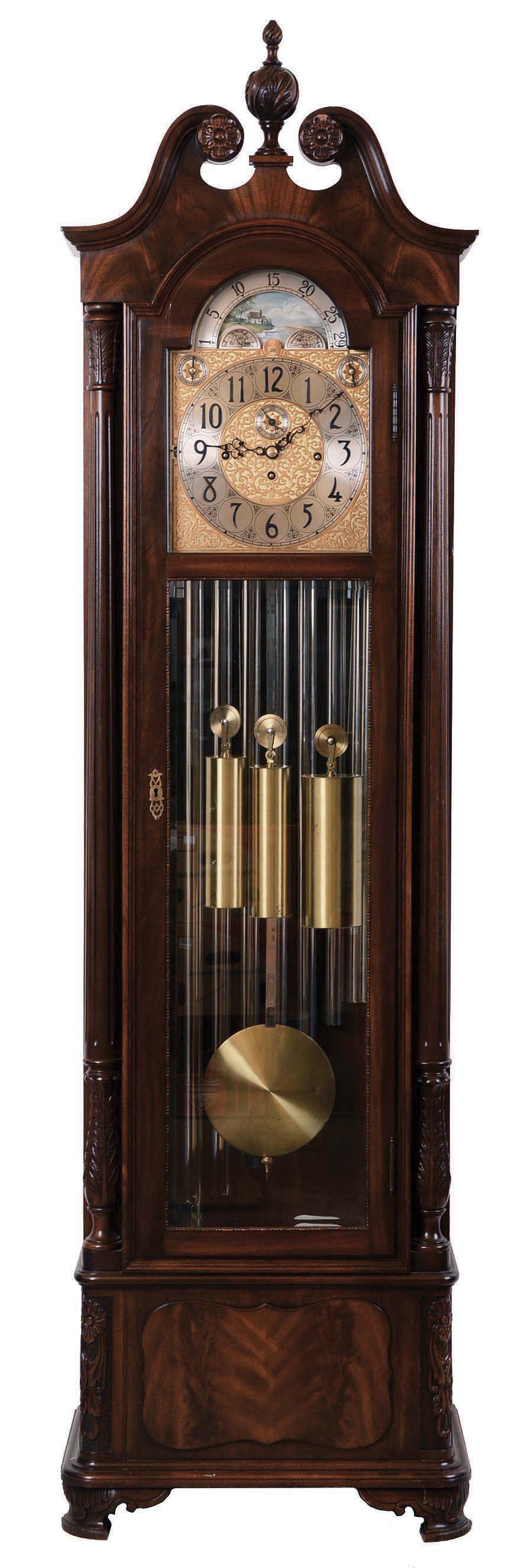 Herschede Clock Co., Cincinnati, Ohio, "Haverford No. 294" hall clock, 8 days, time, strike &amp; chime, three brass weight driven movement playing three tunes on 9 tubes, Westminster, Wittington, Canterbury in a mahogany case with fluted columns with Acanthus carved capitals and bases, cutout base with raised burl panel, bracket feet and beveled glass sides and door, The broken arch top has carved floral rosettes and a finely carved center finial. The brass dial silvered chapter ring and tune and strike / silent selectors, applied cast brass and engraved dial center and spandrels and moon phase, serial no. 628255 — Antique Clocks Price Guide