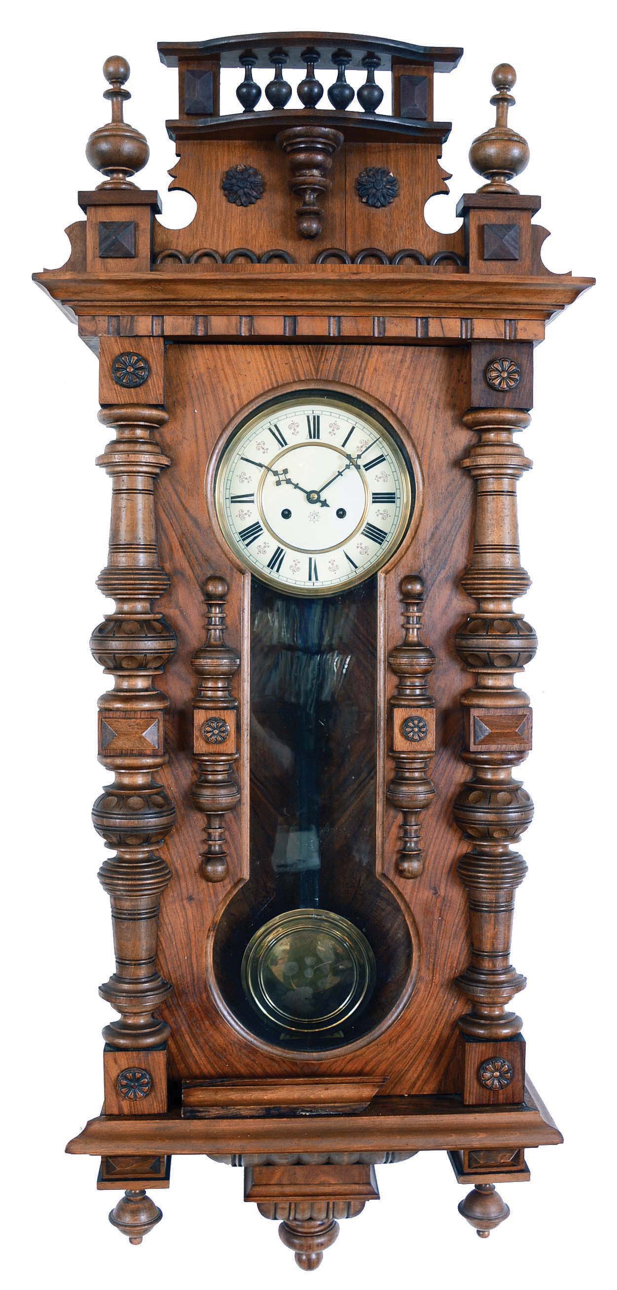 Clocks- 2 (Two) Vienna regulators, Germany, 8 days: (1) Junghans, Wurttemberg, time and strike, spring driven movement in a carved Alt Deutsch walnut case with barbell shaped glazed window in door, turned elements and pressed brass pendulum The dial is a cream enamel two part with Roman numerals. (2) Germany, time only, brass weight driven movement in a walnut case with two part white enamel dial and second's bit — Antique Clocks Price Guide