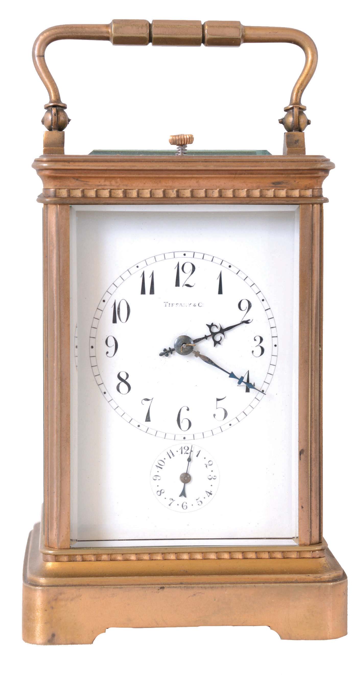 France, for Tiffany &amp; Co., grand sonnerie striking carriage clock with alarm, gilt Corniche variant case with beveled glasses, Arabic numeral white enamel dial with subsidiary alarm chapter, blued steel hands, 8 day quarter striking movement with lever platform, striking the hours and quarters in passing, and repeating on demand — Antique Clocks Price Guide