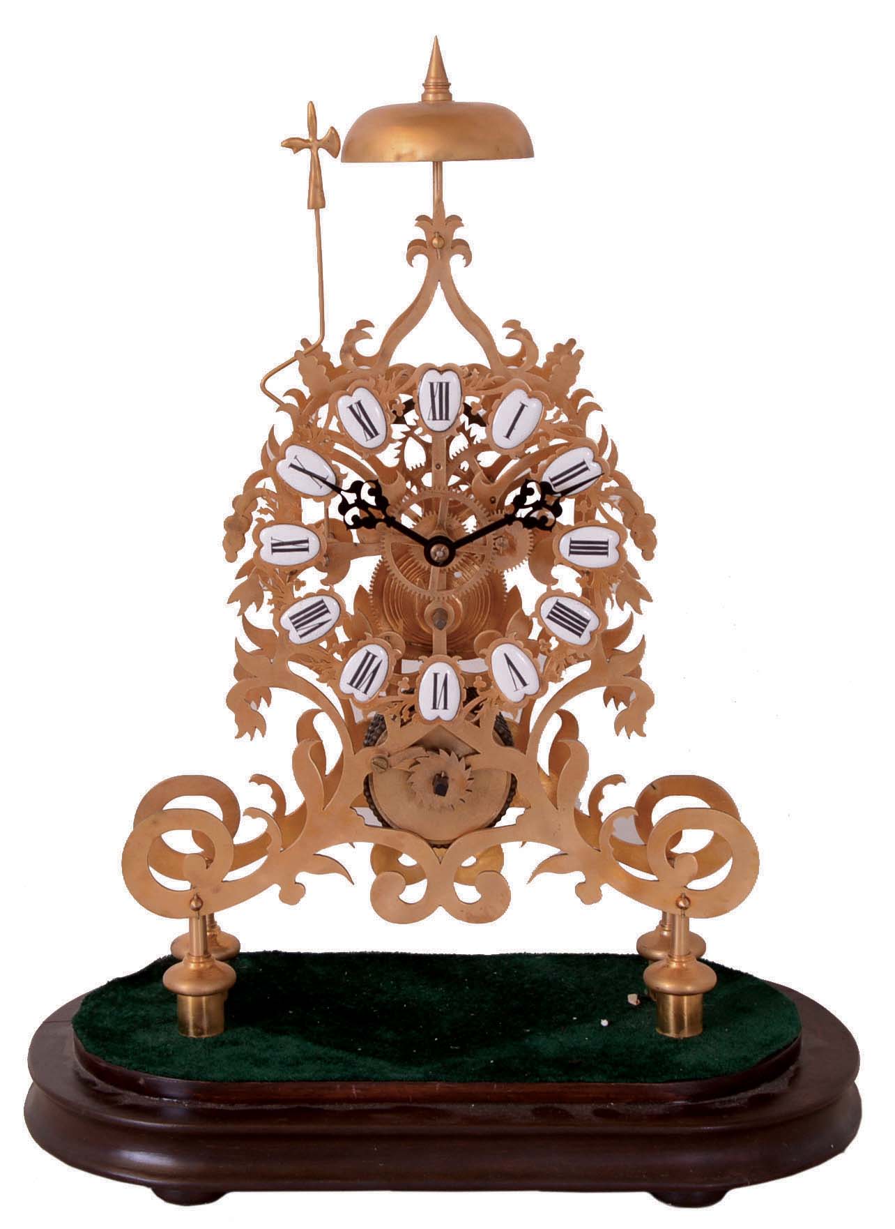 Reproduction skeleton clock, Chinese, brass framed chain fusee movement with white enamel Roman numerals on a wooden base with brass feet, — Antique Clocks Price Guide