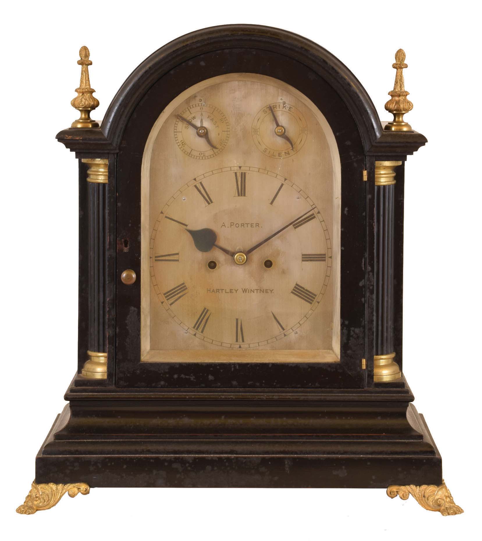 A. Porter, Hartley Wintney, England, bracket clock, the ebonized case with heavily molded base and molded arch top, fluted quarter columns, gilt paw feet and gilt crocket and pinnacle finials, Roman numeral silvered dial with strike control and rating chapter at top, blued steel hands, 8 day two train fusee movement, striking the hours on a large gong — Antique Clocks Price Guide