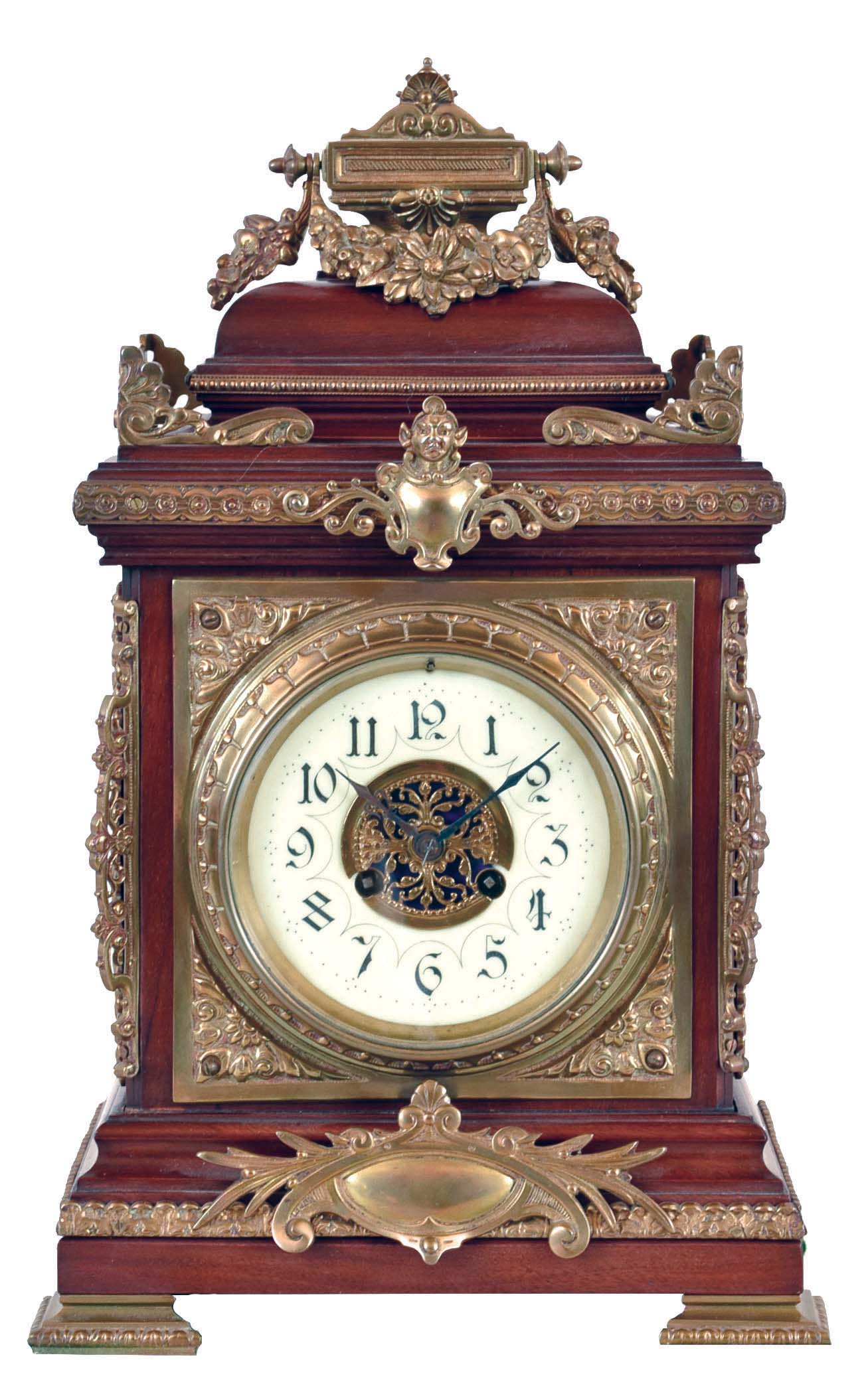 Germany, shelf clock, the mahogany case laden with a profusion of cast brass ornament, Arabic numeral white enamel dial, blued steel hands, 8 day, time and strike pendule a Paris movement, counting the hours on a gong — Antique Clocks Price Guide