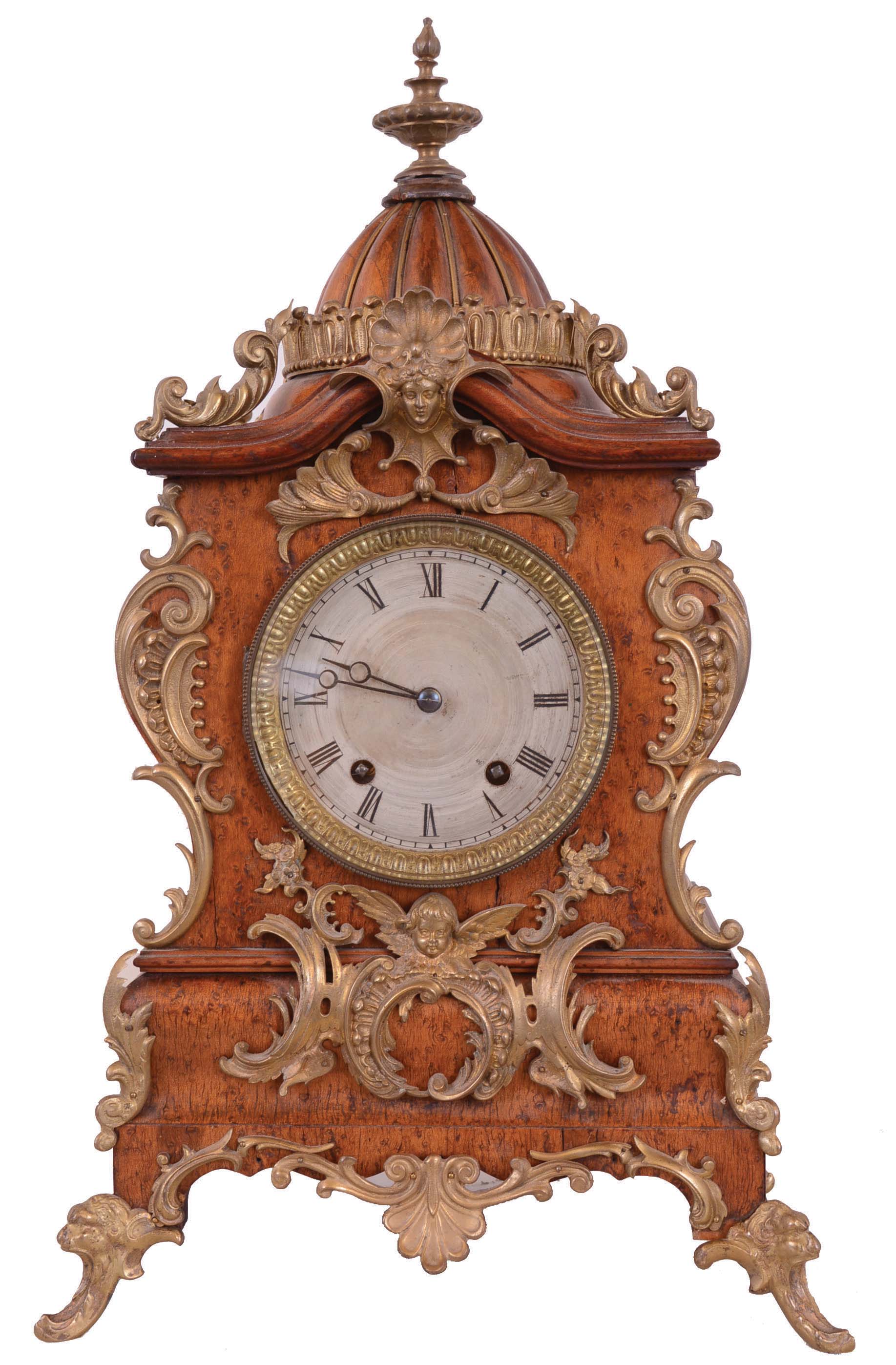 Lenzkirch Clock Co., Germany. 8 day time &amp; strike mantel clock with dome topped wood case, fancy metal feet and applied metal decoration. Serial number 824081. — Antique Clocks Price Guide