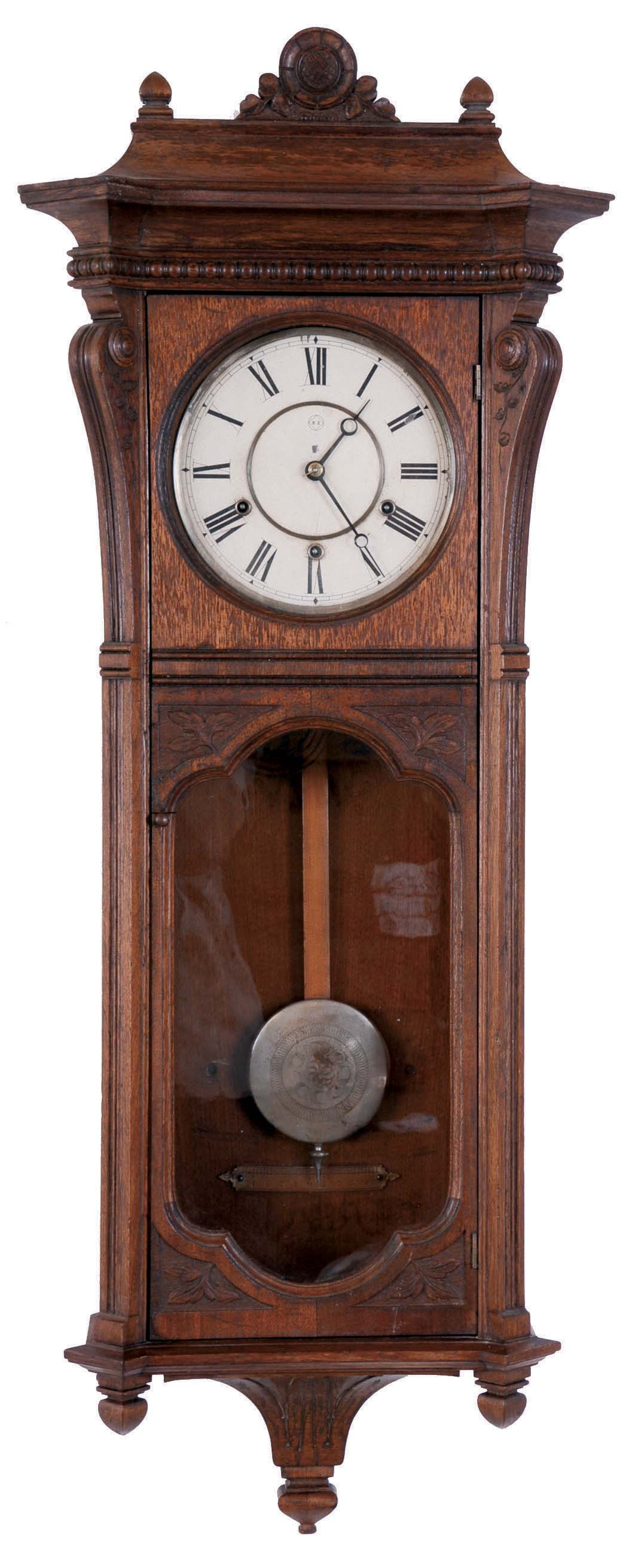 Seth Thomas Clock Co., Thomaston, Conn., "Marcy" wall clock in an oak case with a three train, 8 days, spring driven movement, striking the quarter hours on 2 cup bells and the hours on a cathedral gong, — Antique Clocks Price Guide
