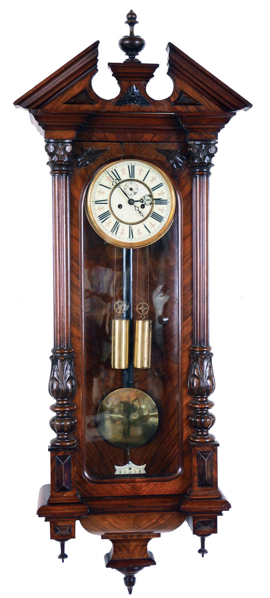 Germany, Vienna regulator wall clock, 8 days, time and strike, brass weight driven movement in a carved architectural walnut case with book matched veneers and cream enamel dial. — Antique Clocks Price Guide
