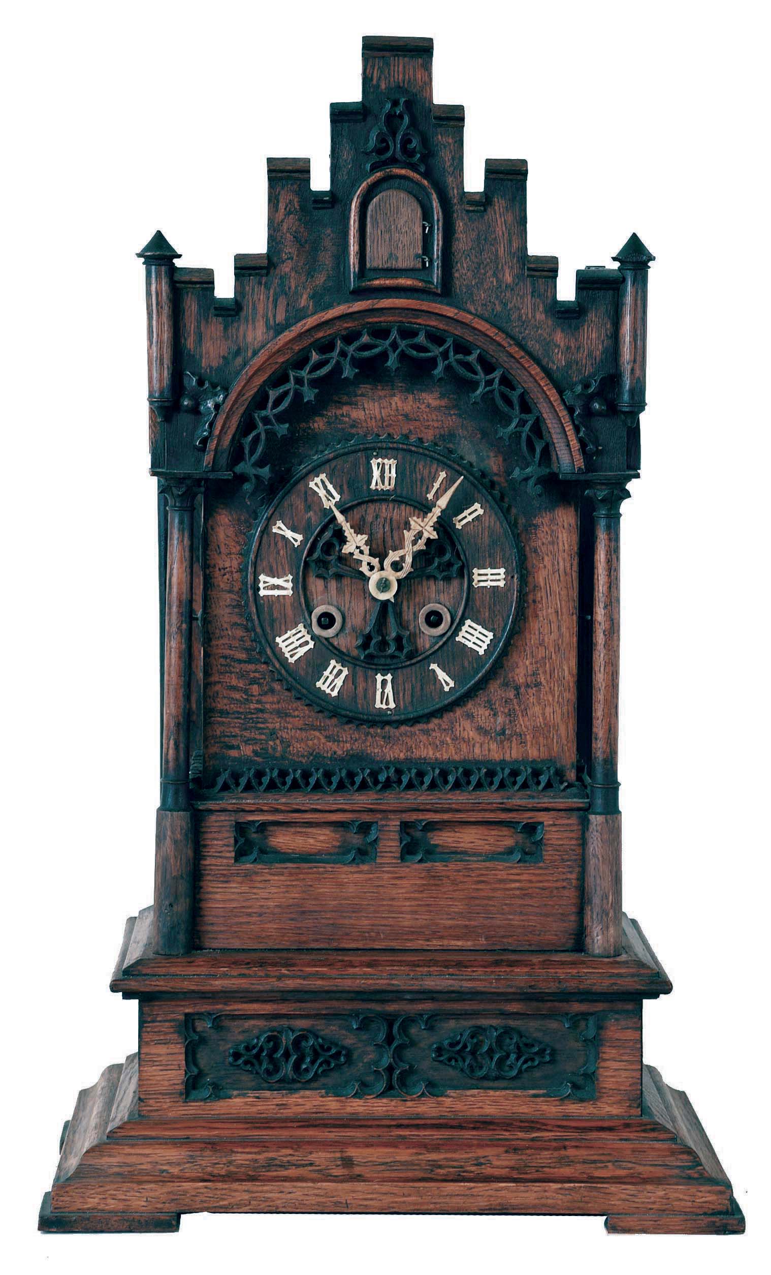 Samuel Kammer, Germany, Gothic style shelf cuckoo, the architectural oak case with turned columns, turrets, carved Gothic foils and fretwork, crenellated parapet and gable, on a heavy, ogee molded base, turned wooden dial with applied Roman numerals, carved bone hands, 8 day, pierced brass time and strike movement, with fusee for time train and going barrel for striking — Antique Clocks Price Guide