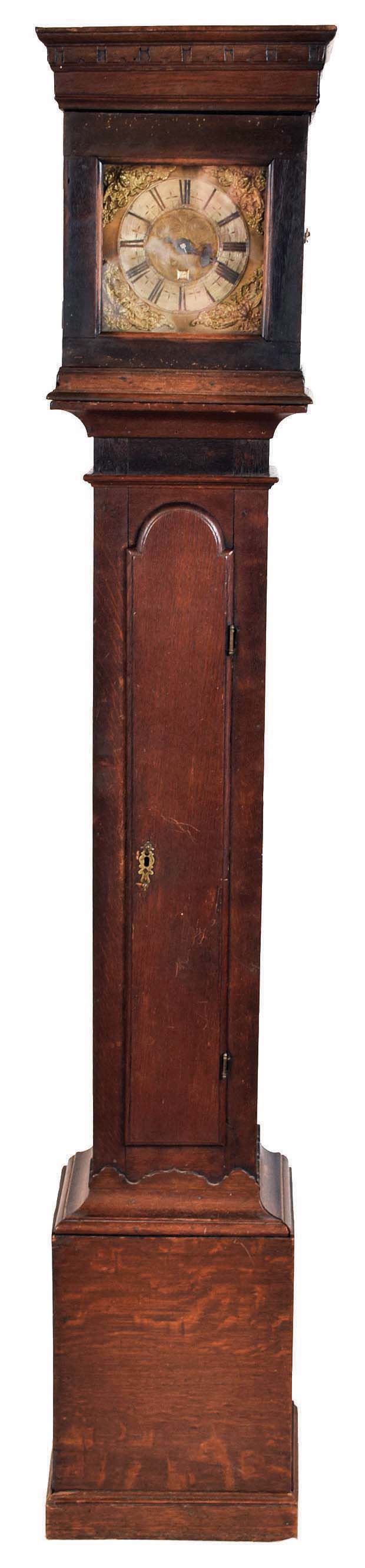 Unsigned, English, single handed tall clock, 30 hour, time and strike, single weight driven posted frame movement in a flat topped oak case with brass dial and silvered chapter ring and applied cast brass spandrels and engraved dial center. — Antique Clocks Price Guide