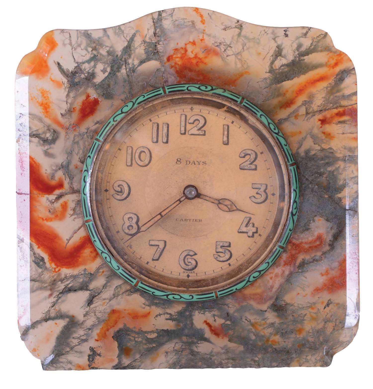 Cartier, desk or bedside clock with easel back, carved and polished moss agate case with enamel bezel, 8 day, 15 jewel timepiece movement, the rear cover signed "Lemania Watch Co. Swiss" and Arabic numeral metal dial, 3 3/8" w x 3 1/2" h — Antique Clocks Price Guide
