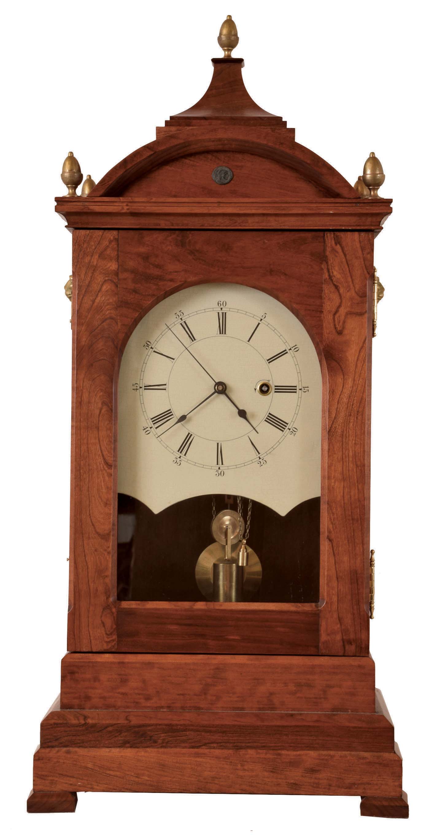 Leland Hurst, large bracket clock with remontoire, cherry case with pagoda top, acorn finials and lion mask handles, Roman numeral painted dial, black spade hands, and with sweep seconds, brass movement with spring powered remontoire, wound through the dial, which rewinds the weight at regular intervals, brass pendulum, late 20th century — Antique Clocks Price Guide