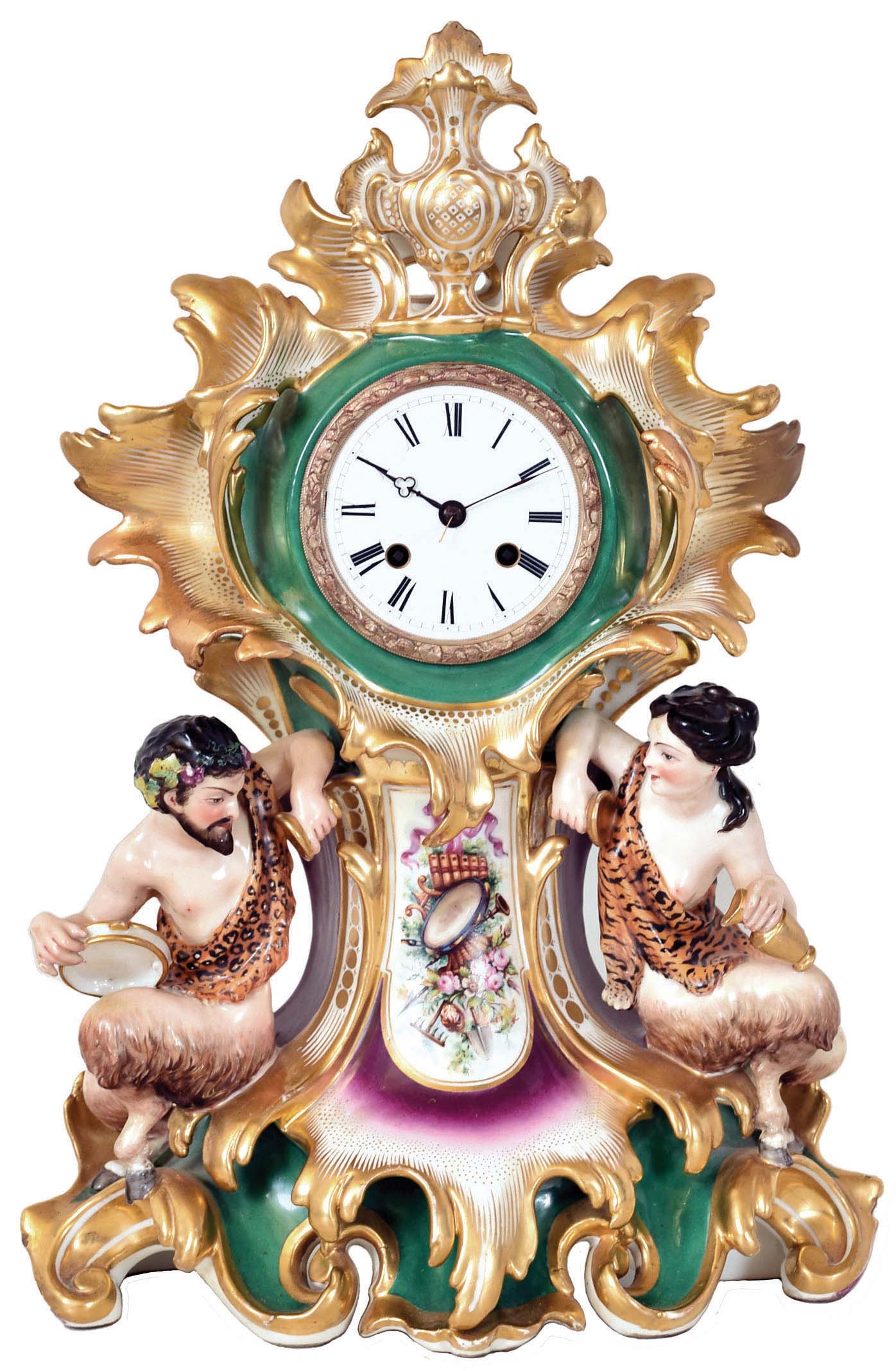 Japy Freres, Paris, France, also marked Cardien, Paris &amp; Cheron, polychrome painted porcelain figural mantel clock, 8 days, time and strike, spring driven movement with silk thread suspension in a highly decorative porcelain case featuring a male and female satyr flanking a painted horn of plenty with white enamel dial. — Antique Clocks Price Guide