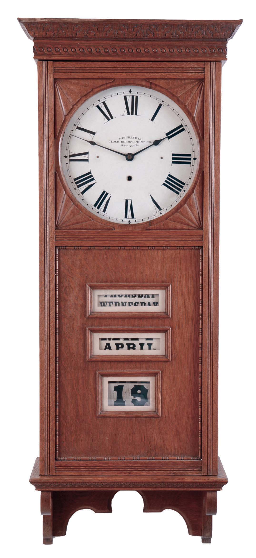 Prentiss Improvement Clock Co., New York, NY. "Standard" with calendar wall clock with a spring driven 30 day movement and a spring driven calendar movement in an oak case. — Antique Clocks Price Guide