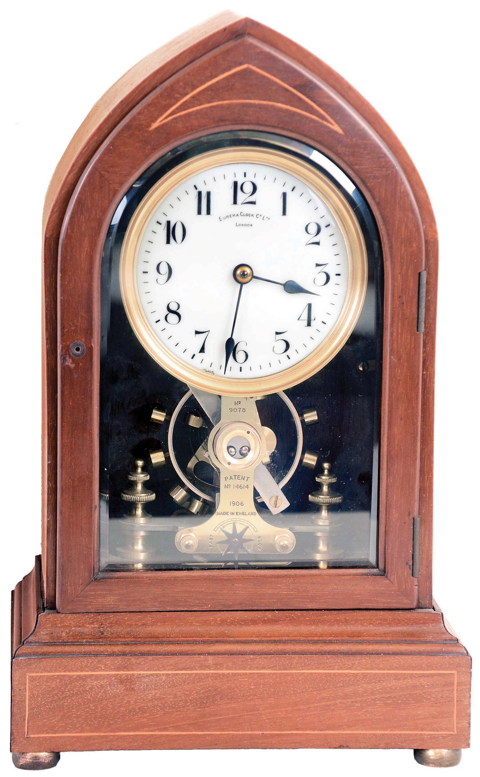 Eureka Clock Co. Ltd., London, England, battery powered mantel clock with oversized balance wheel movement in an inlayed mahogany case with beveled glasses and cream porcelain dial, s#9078 — Antique Clocks Price Guide