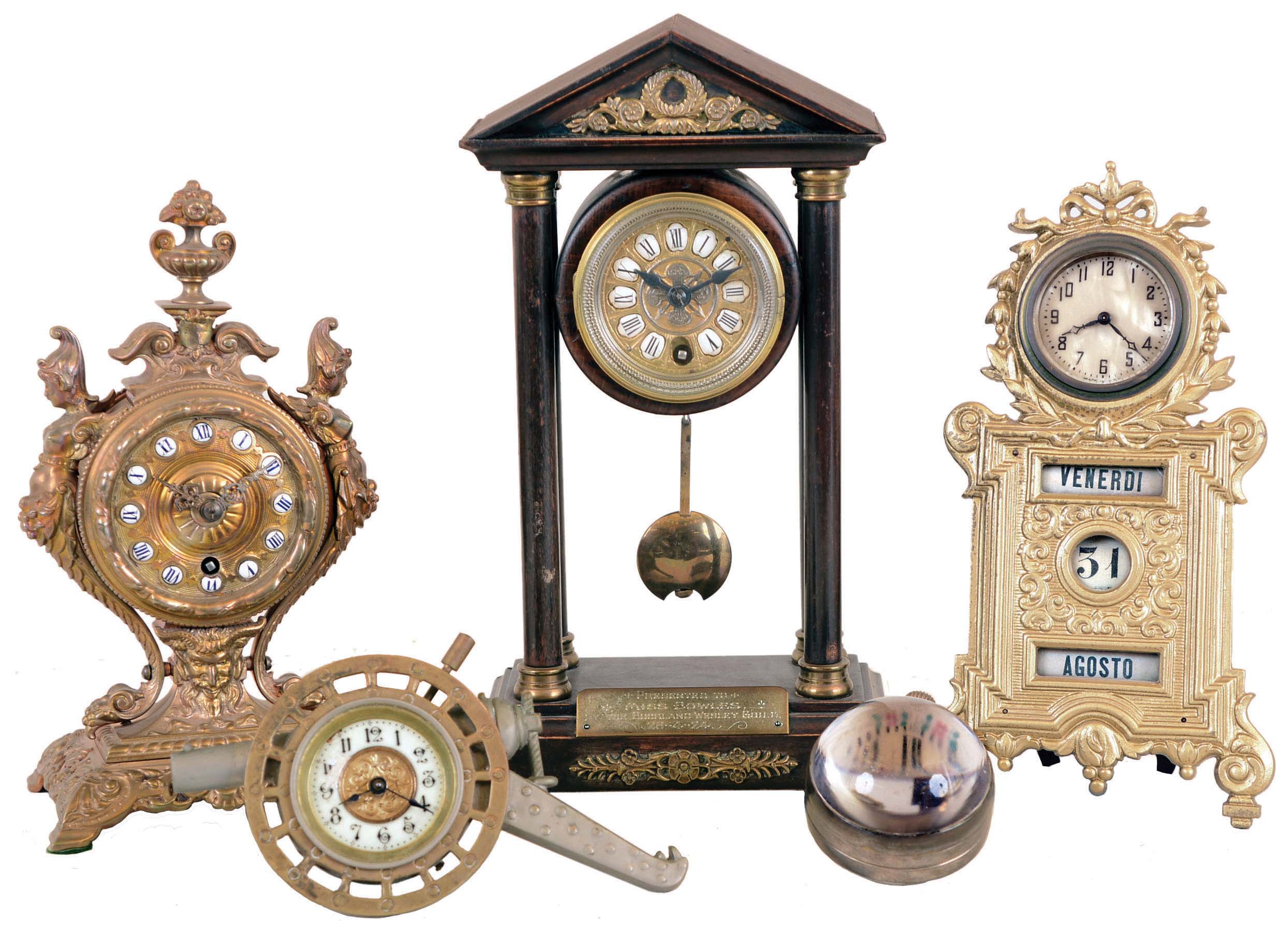 Clocks- 5 (Five) Desk: French 8 day cast brass figural with cylinder platform; cast brass-front 30 hour American with manual calendar; Swiss 30 hour glass paperweight; British United cannon-form 30 hour; Hamburg-American German small portico 8 day with pendulum; early 20th century — Antique Clocks Price Guide