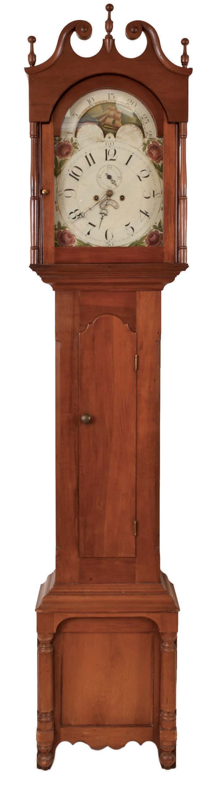 Pennsylvania tall clock, 8 day, time and strike, weight driven movement in a cherry case with broken arch top, three wooden finials on bracket base with applied turnings. The painted iron dial, attributed to William Jones, Philadelphia dial manufacturer, has rose spandrels, moon phase with ship of the line scene, date aperture and second's bit. — Antique Clocks Price Guide