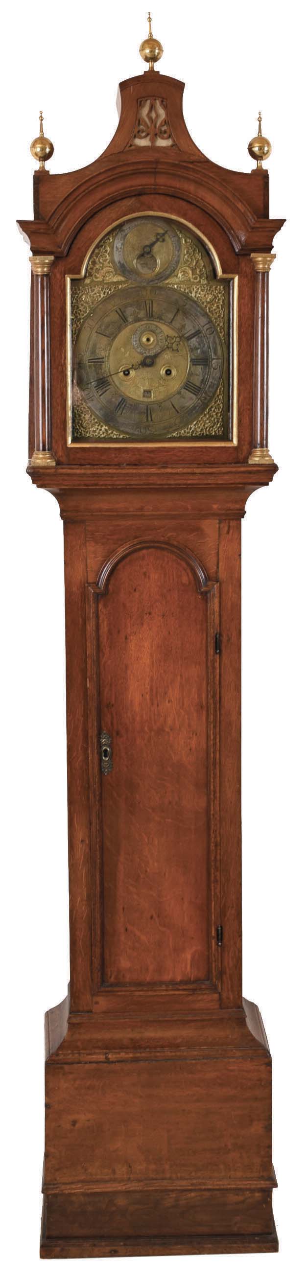 Timothy Mason, Gainsborough, England, tall clock. 8 day, time and strike, weight driven movement, c1720, in a c1770 pagoda top oak case with brass finials. Early brass dial with silvered chapter ring, ringed winding holes, engraved center, date calendar, second's bit, applied brass spandrels, dolphins in arch flanking the silvered penny-moon phase and signed by maker engraved on chapter ring at 6. — Antique Clocks Price Guide