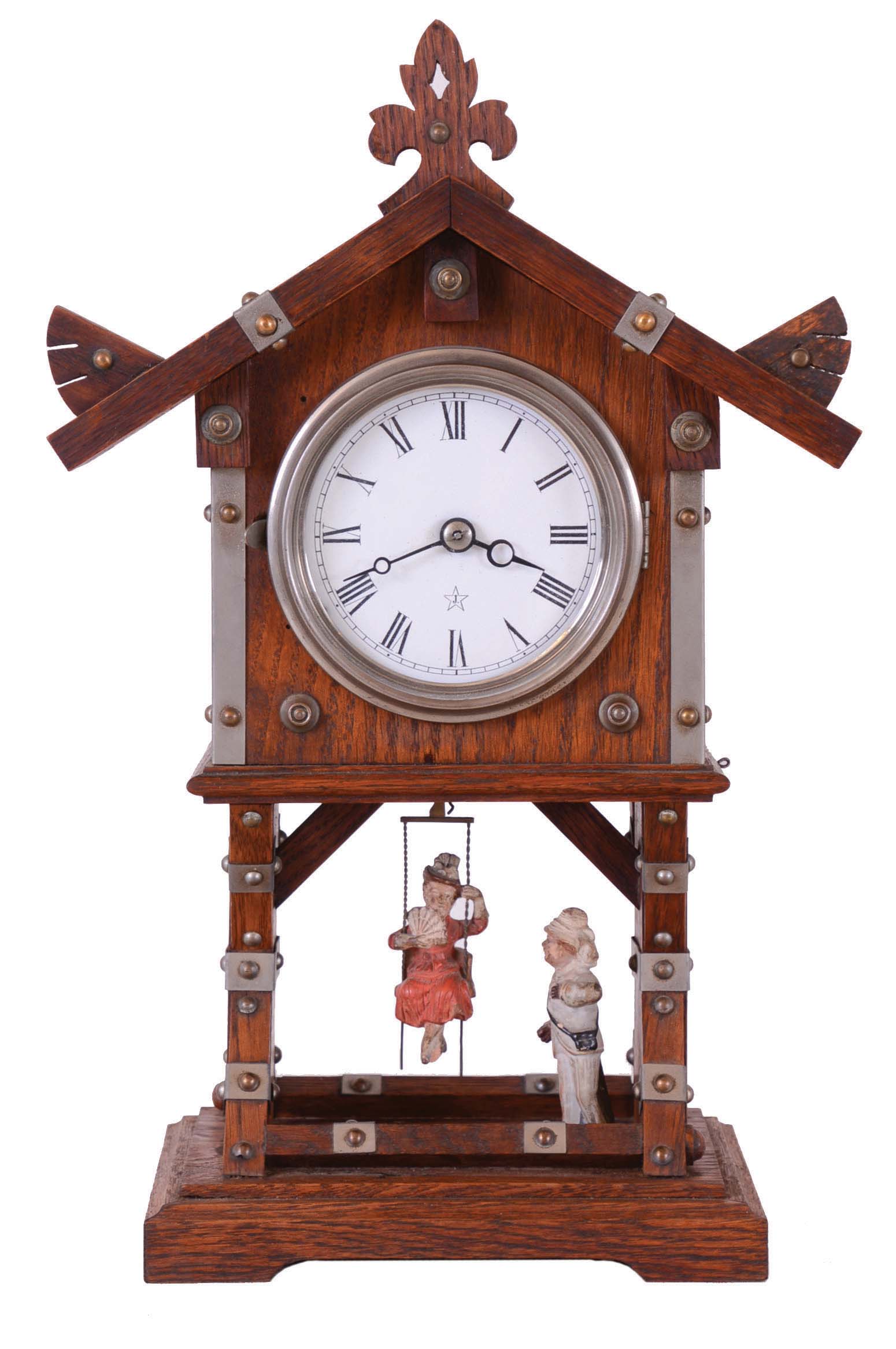 Junghans, Germany swinging doll novelty mantel clock, 8 days, time only, spring driven movment wound from the side of an oak case in the form of a chalet with bisque figures of a well dressed man pushing a young Victorian lady on a swing. The white enamel dial is marked with Junghan's trademark. — Antique Clocks Price Guide
