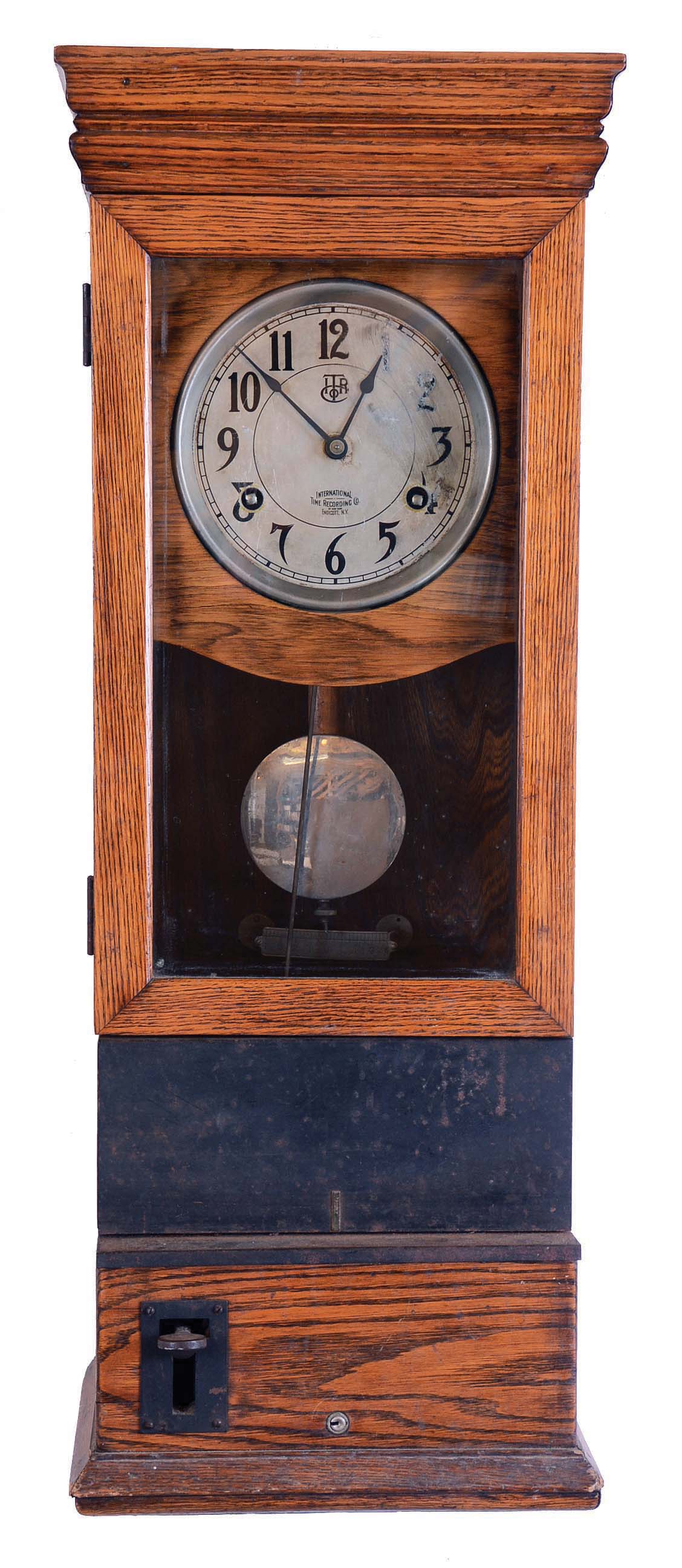 International Time Recording Co., Endicott, New York, punch clock, 8 days, time only, spring driven movement duration in an oak case with a silvered dial. and nickeled pendulum bob. — Antique Clocks Price Guide