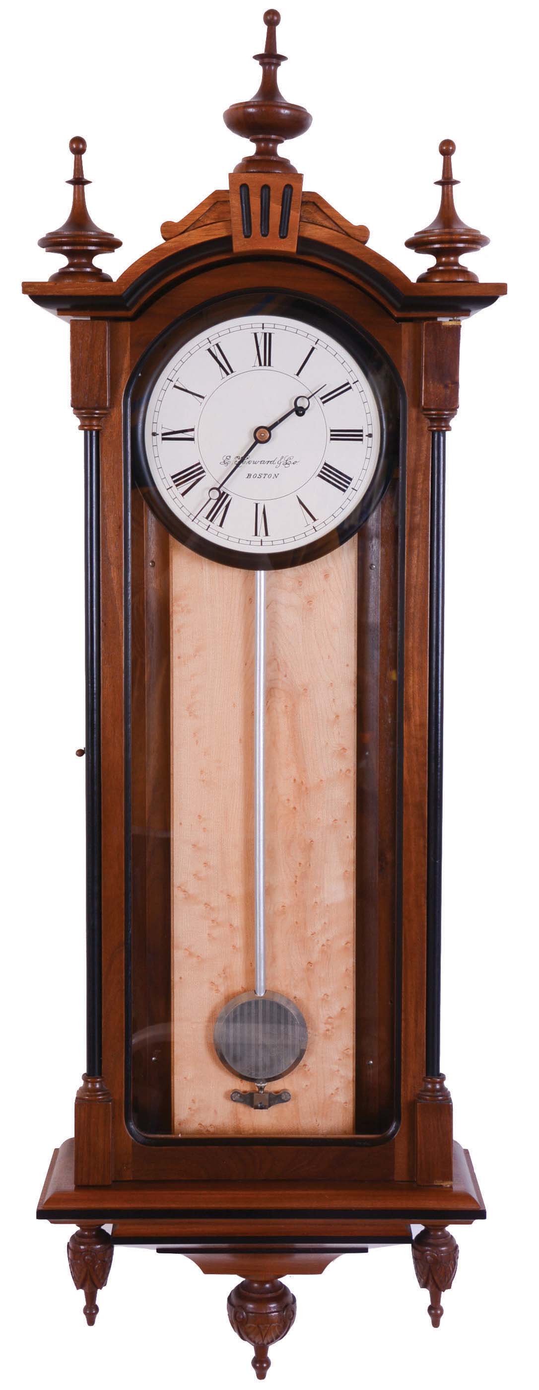 E. Howard &amp; Co., Boston, Mass., "Regulator No. 59-8" reissue. Walnut case with ebonized moldings, turned and carved finials, maple weight baffle, ebonized wooden bezel with Roman numeral white painted 8" dial, blued steel moon hands, damascened nickel pendulum with silver painted wooden rod, 8 day weight driven timepiece movement, The clock has serial number 84 and is dated August, 1976. — Antique Clocks Price Guide
