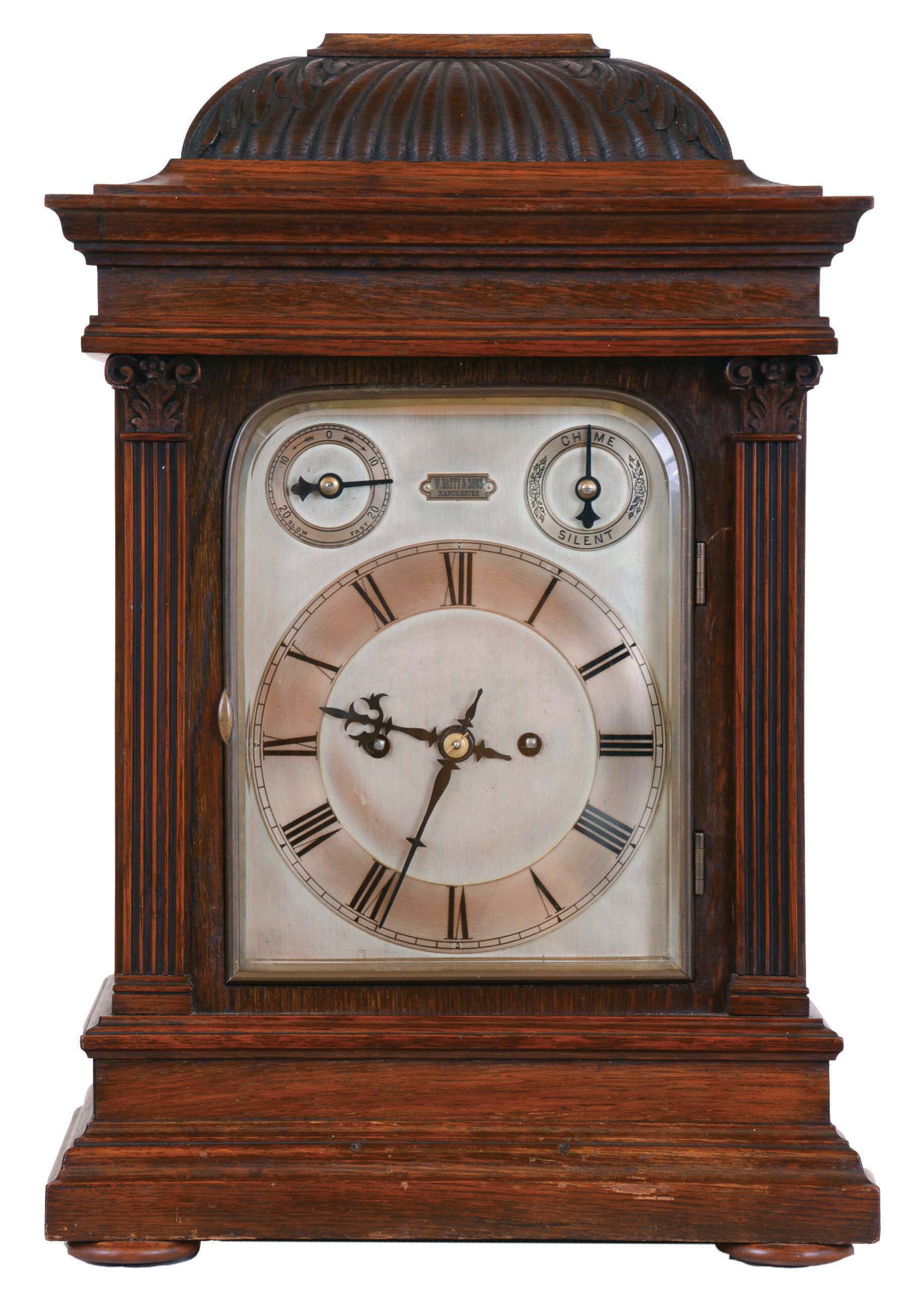 Winterhalder &amp; Hofmeier, Germany, for W. Batty &amp; Sons, Manchester, England, bracket clock, architectural oak case with fluted pilasters, gadrooned caddy top with acanthus carved corners, silvered dial with Roman numeral chapter ring, and with rating and chime control dials, blued steel hands, 8 day, 2 train fusee movement, with ting tang quarters and hour striking on gongs, back plate signed — Antique Clocks Price Guide