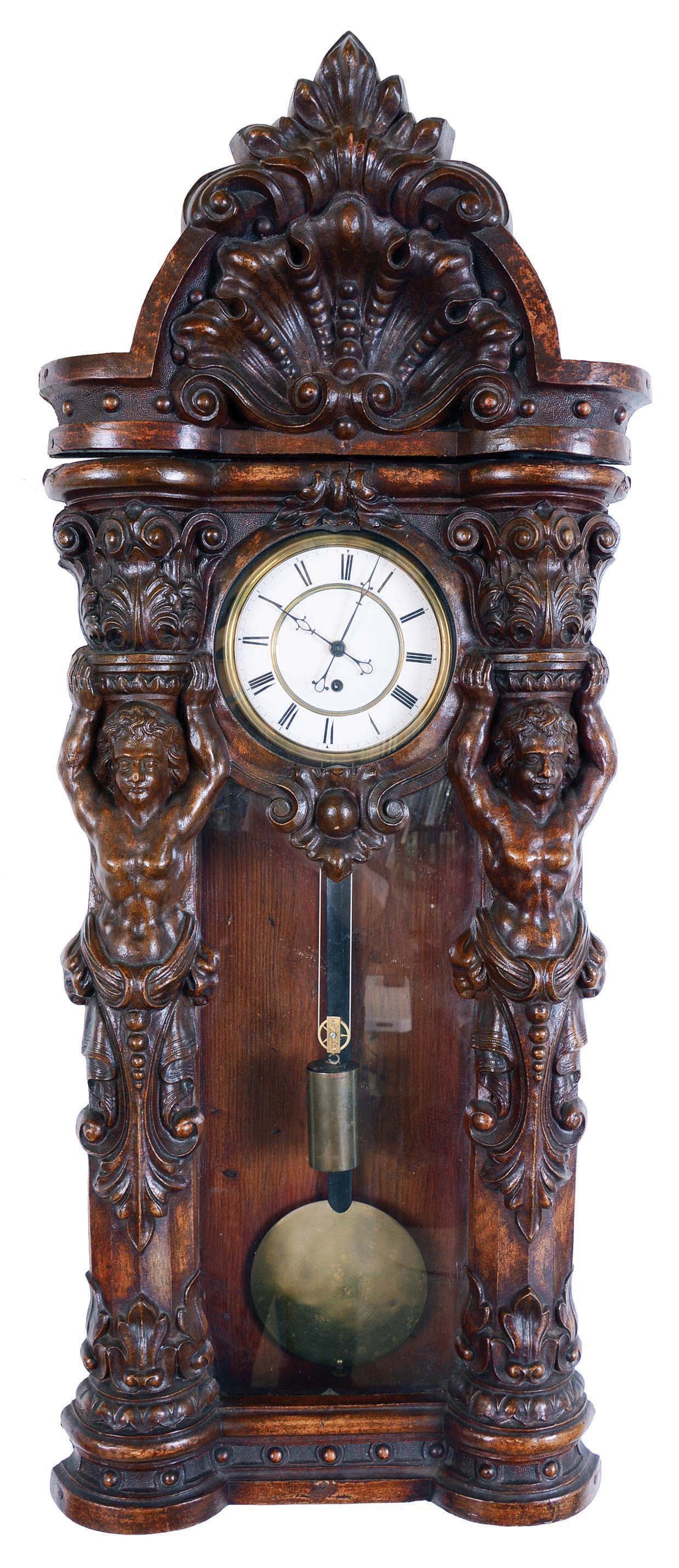 Germany, paper mache Vienna regulator wall clock, 8 days, time only, weight driven movement in a soft wood case with paper mache front depicting two female nudes flanking hood door supporting capitals above heads. The two part white enamel dial has Roman numerals. — Antique Clocks Price Guide