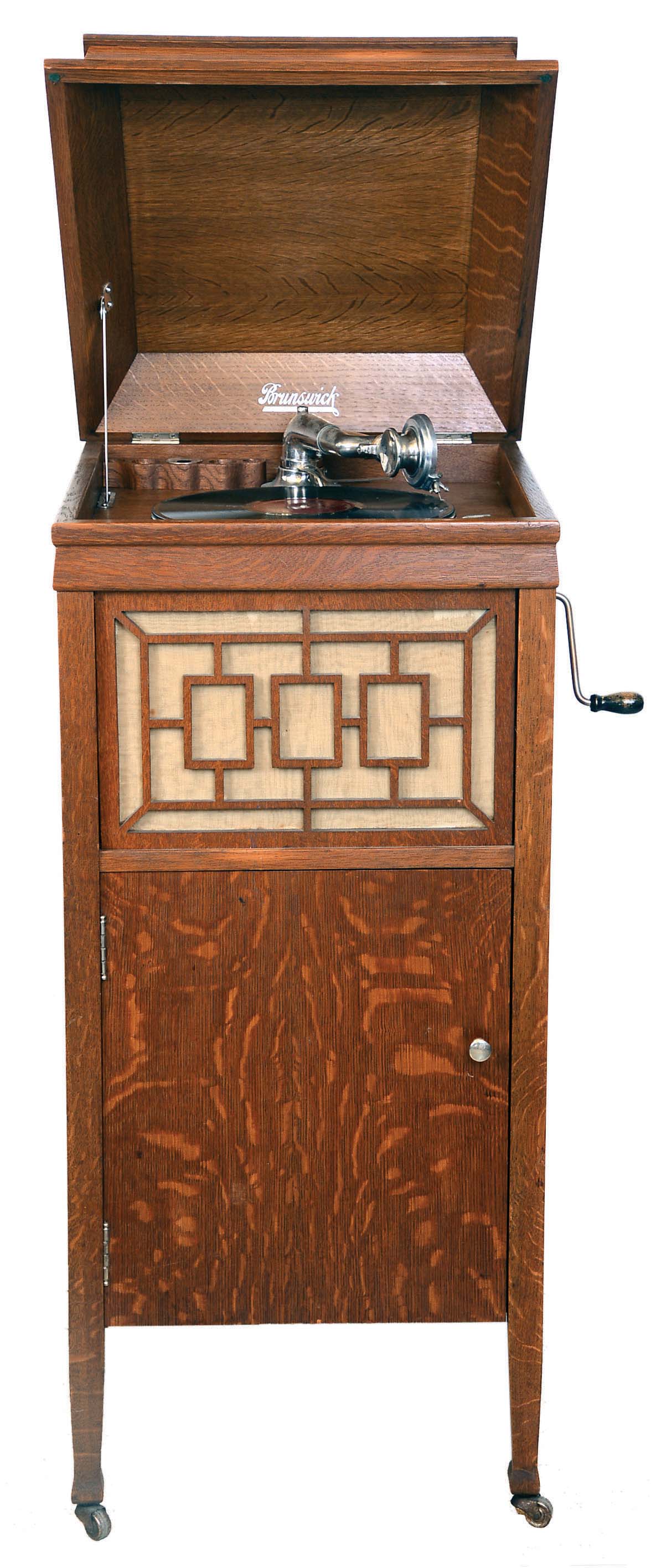Brunswick Balke Collender Co,, Chicago, IL. "Model 7" floor standing disc phonograph, serial #123506. It has automatic shut off and an adjustable reproducer which will play regular 78" RPM discs and Pathe' discs. Quarter-sawn oak case. — Antique Clocks Price Guide