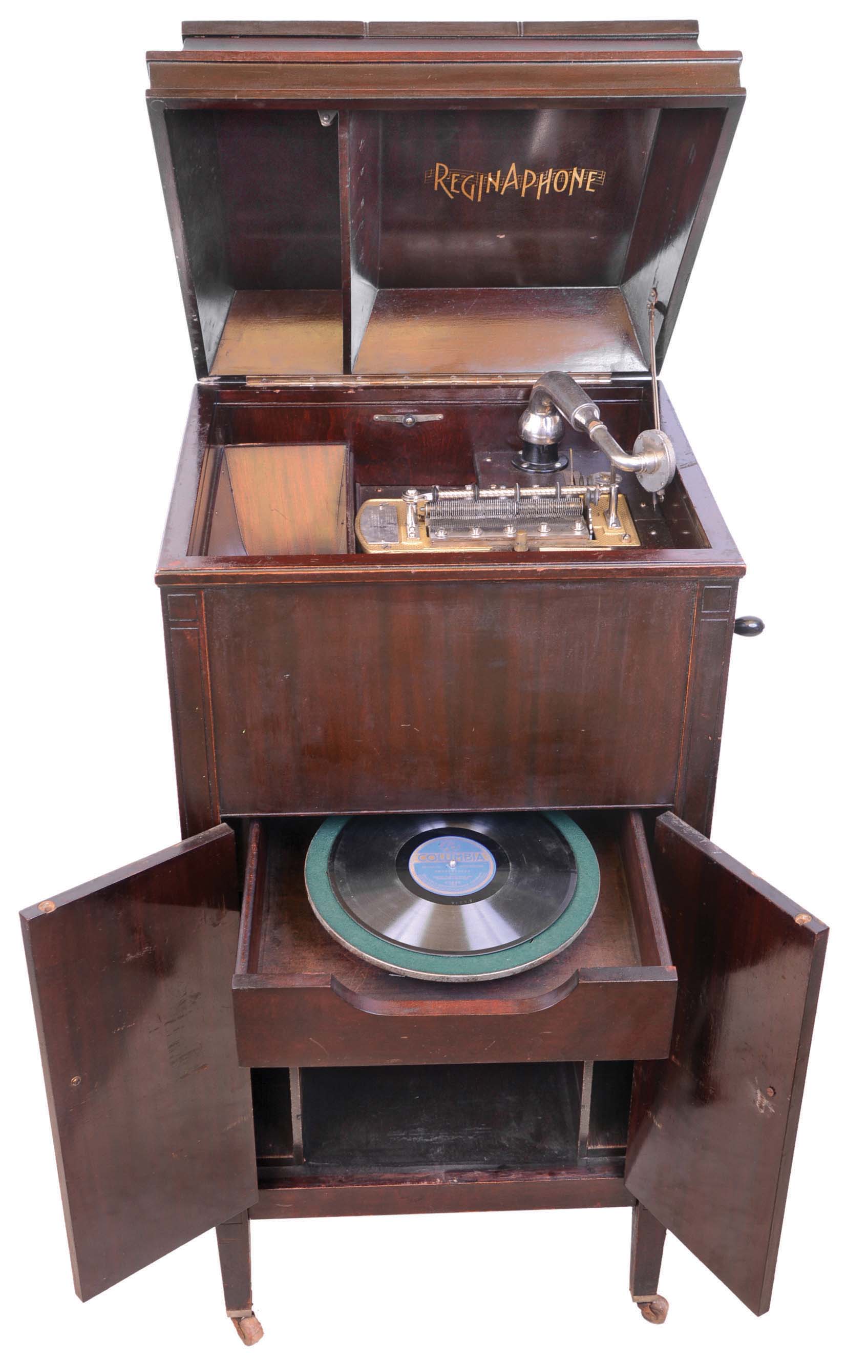 Regina Music Box Co., Rahway, NJ. "Style 246 Regina phone serial number 2460162. This was the last model of combination disc music box and 78 rpm phonograph with interior horn. Only 190 examples of this model were made and shipped. The music box has a short bed plate and double comb for superb sound. It plays 15 1/2 inch discs. The floor standing case has storage below for discs and records. — Antique Clocks Price Guide