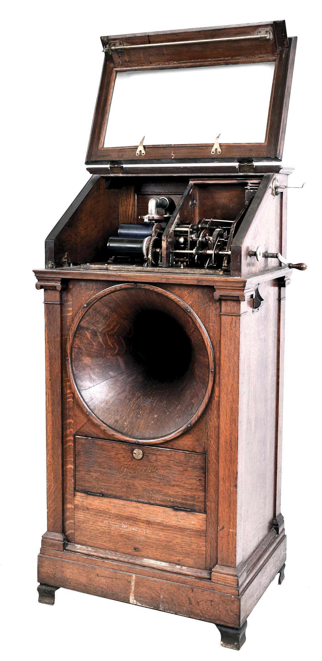 Regina Music Box Co., Rahway, NJ. Coin operated "Hexaphone", Model 104 with wood horn, serial #1040627. This predecessor to the modern-day juke box. It will play one of six Edison 4-miinute Blue Amerole cylinders selected after a nickel is inserted. — Antique Clocks Price Guide