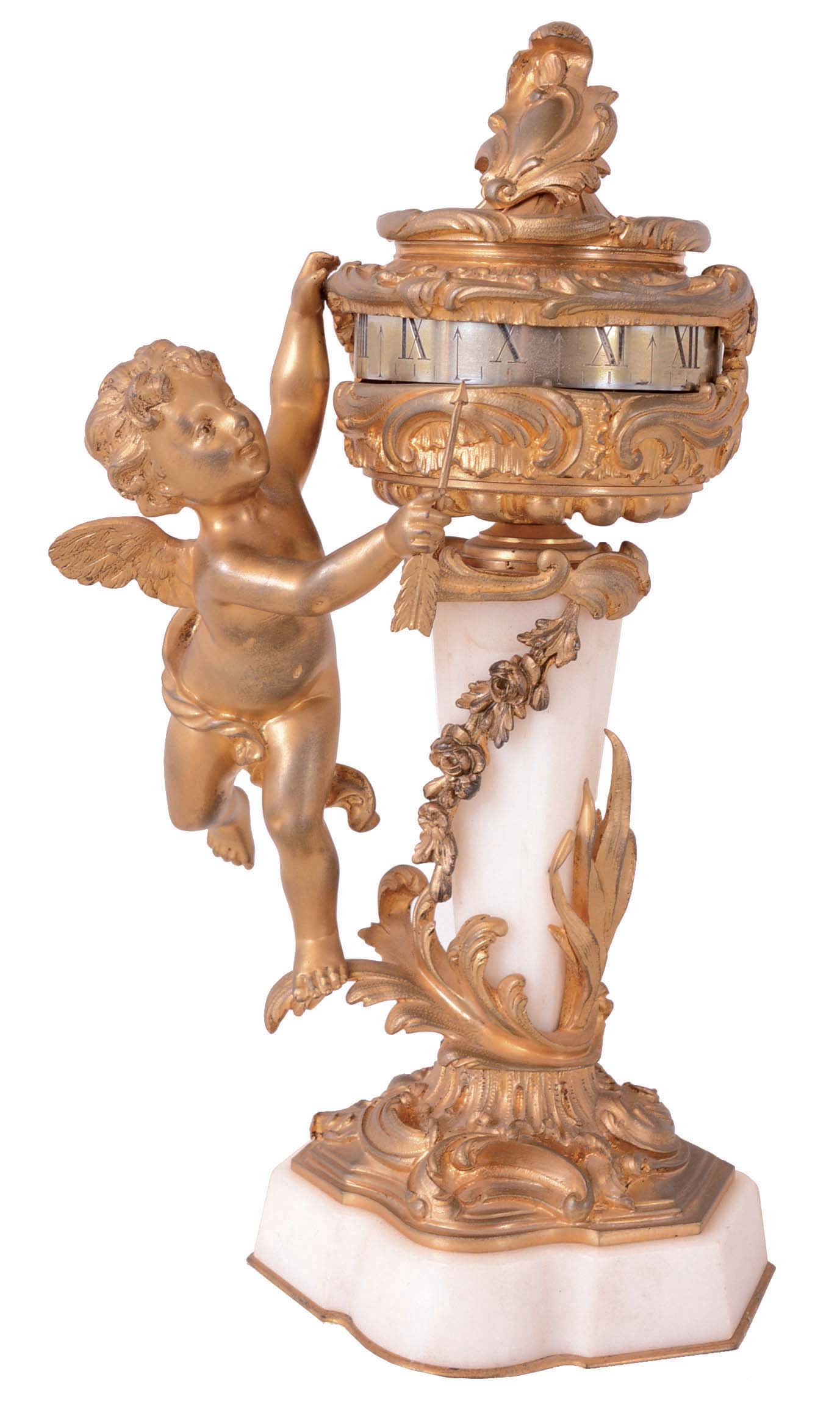 France, for Gubelin, Switzerland, desk clock with annular dial, gilt brass and marble, with rococo ornament, the urn form case supported on a stone column resting on a shaped base, and with a putto at left, holding an arrow used to indicate the time, Roman numeral silvered dial, 8 day timepiece movement with lever platform, movement signed — Antique Clocks Price Guide