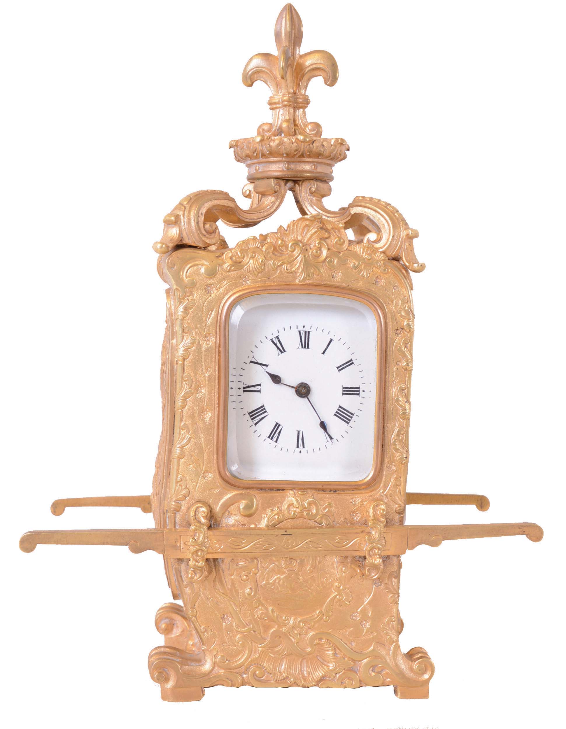 France, for Maple &amp; Co., London and Paris, hour repeating carriage clock in the form of a sedan chair, the gilt brass case with rococo style ornament with plaques featuring naughty putti, scrolls, and shells, case sides with carrying handles, the top with scrolled brackets supporting a fleur de lis finial, and with well executed portrait of a young woman, behind glass at right side, Roman numeral white enamel dial, 8 day time and strike movement with lever platform, counting the hours on a gong, and repeating on demand, movement signed — Antique Clocks Price Guide