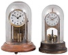 Clocks- 2 (Two) battery powered electromechanical under glass domes: Barr Mfg. Co., on wood base, c1930; Tiffany Never-Wind with torsion pendulum, c1904