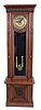 German, tall clock, 2-wt, 8-day time and strike, in a molded case with carved accents.  The round brass dial, embossed and with 2 added holes and arbor extensions for possible winding through the dial.  C.1915